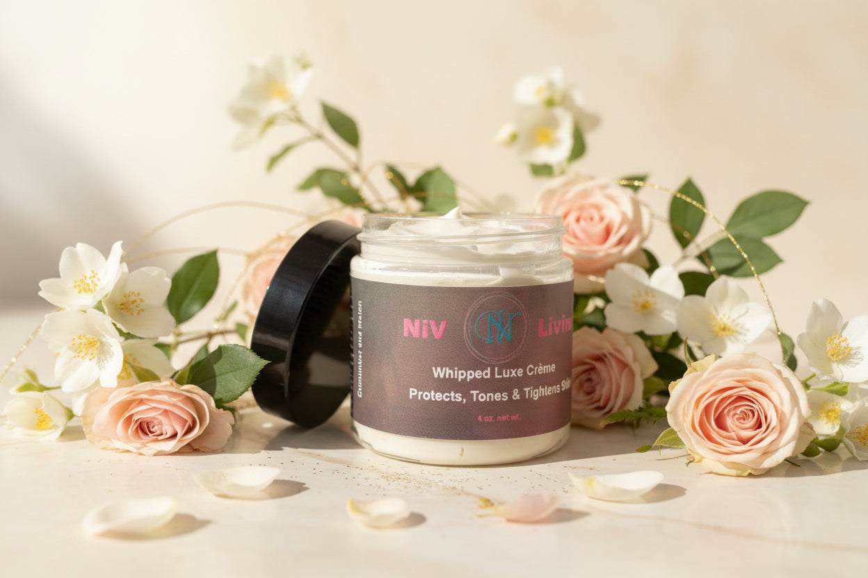 Jar of Niv Whipped Luxe Creme surrounded by flowers on a light background
