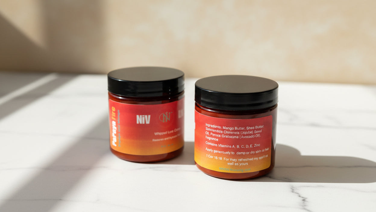 Two jars of hair product on a marble surface with a neutral background